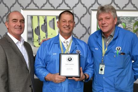 Libra Industries CEO Rod Howell presenting the service award to Bob Thibodeau.